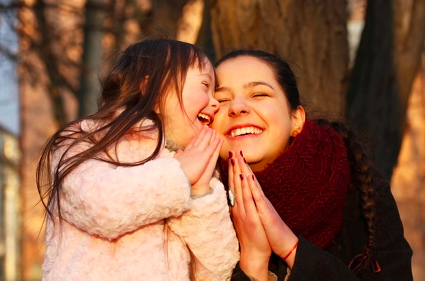 Mujer enseñando a su hija a orar