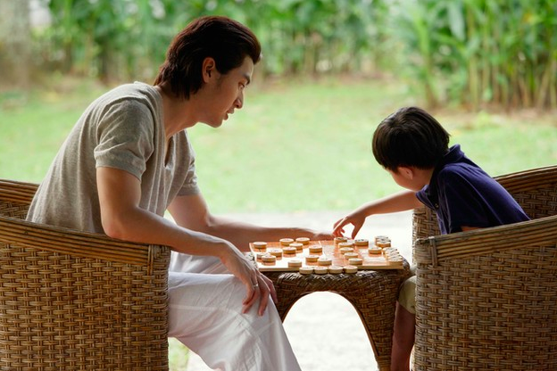 Padre e hijo jugando un juego de mesa