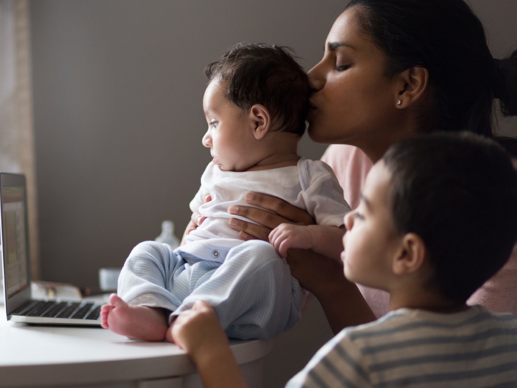 madre besando en la cabeza a su bebe